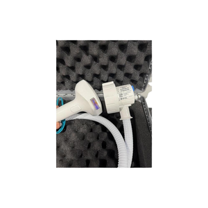 Close-up of InMode Optimas Pre-Owned (2020) handpiece head and cable connector in protective foam case