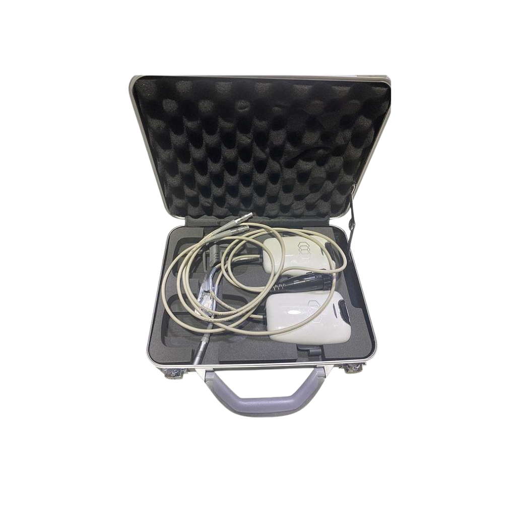 Open case containing a treatment handpiece, cables, and accessories.
