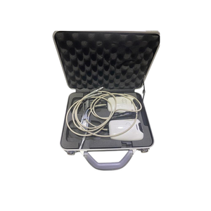 Open case containing a treatment handpiece, cables, and accessories.