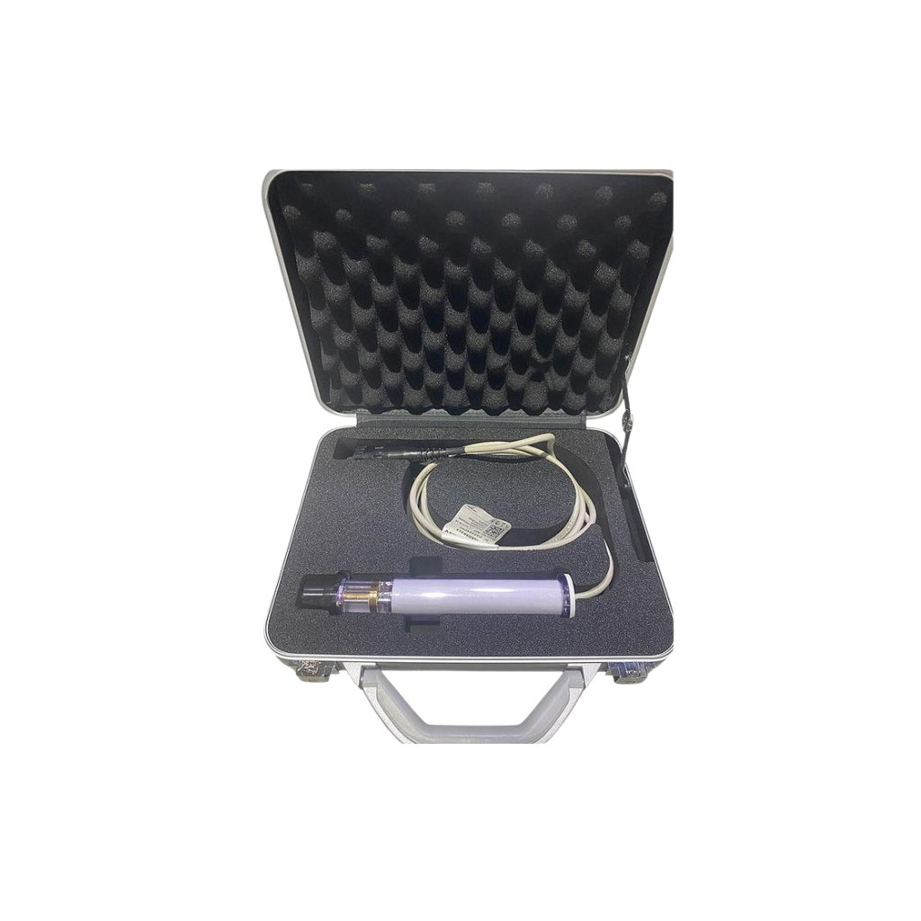 Open case containing a circular treatment applicator, cable, and accessories.