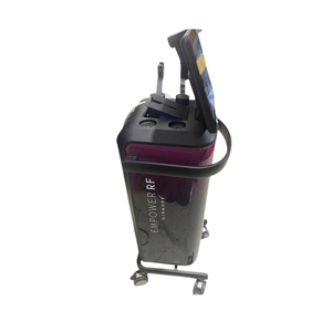 Side view of the InMode Empower RF system on a wheeled stand, showing the main console and attached treatment handpieces.