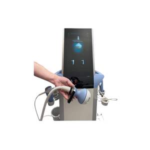 2023 BTL EXION controller view 1 showing a hand holding a treatment handpiece in front of the display screen