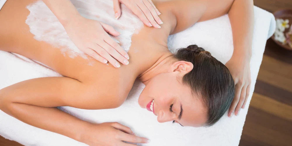 Relaxing back massage with cream being applied to a woman lying down for a soothing and rejuvenating experience