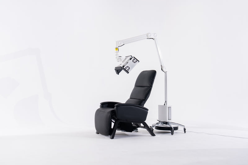 Black recliner chair with a medical device on a white background