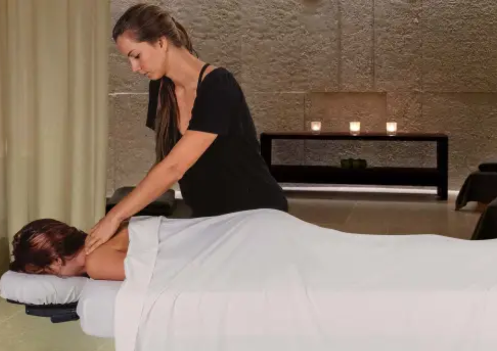 Earthlite Ellora Flat Electric Lift Massage Table demonstrated in setting and practice.
