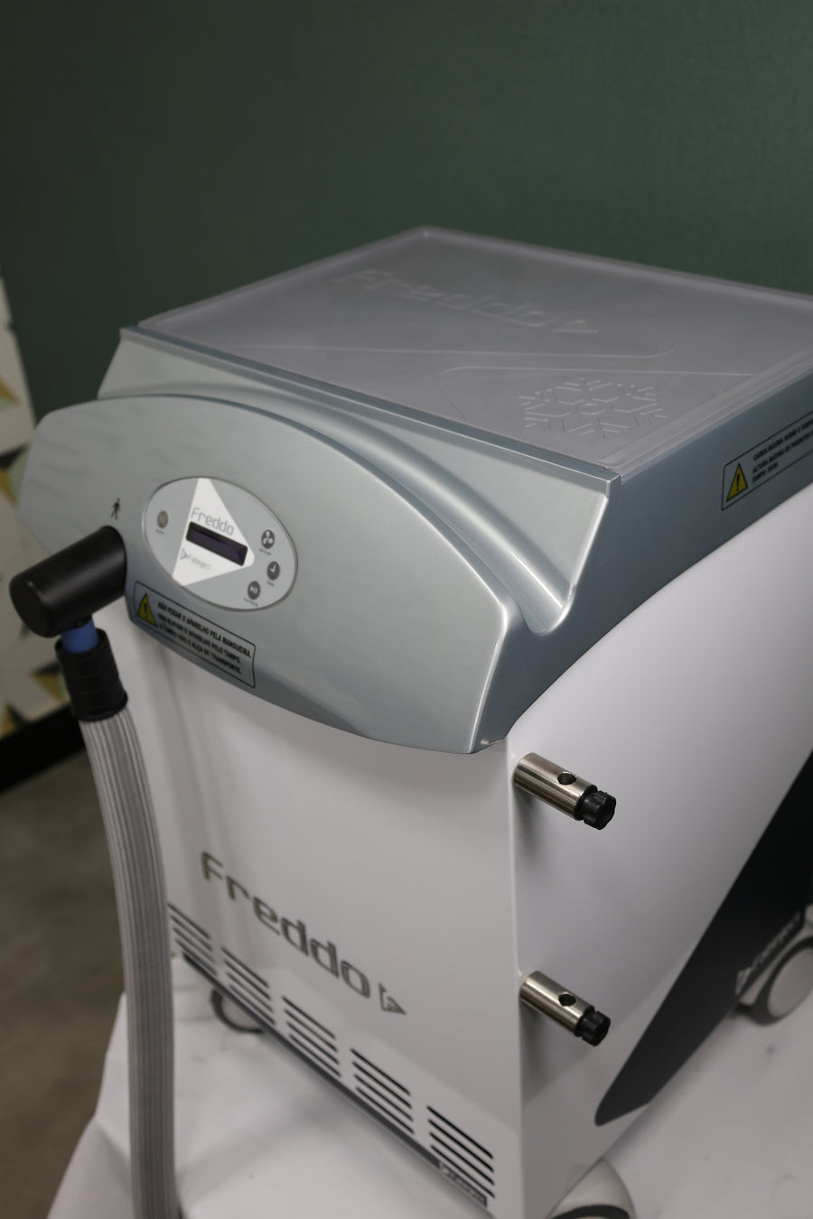 Freddo Aesthetic Skin Cooling Chiller Device  with a green background