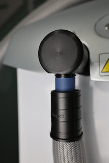 Close-up of the hose outlet of a Freddo Aesthetic Skin  Cooling Device on a blurred background