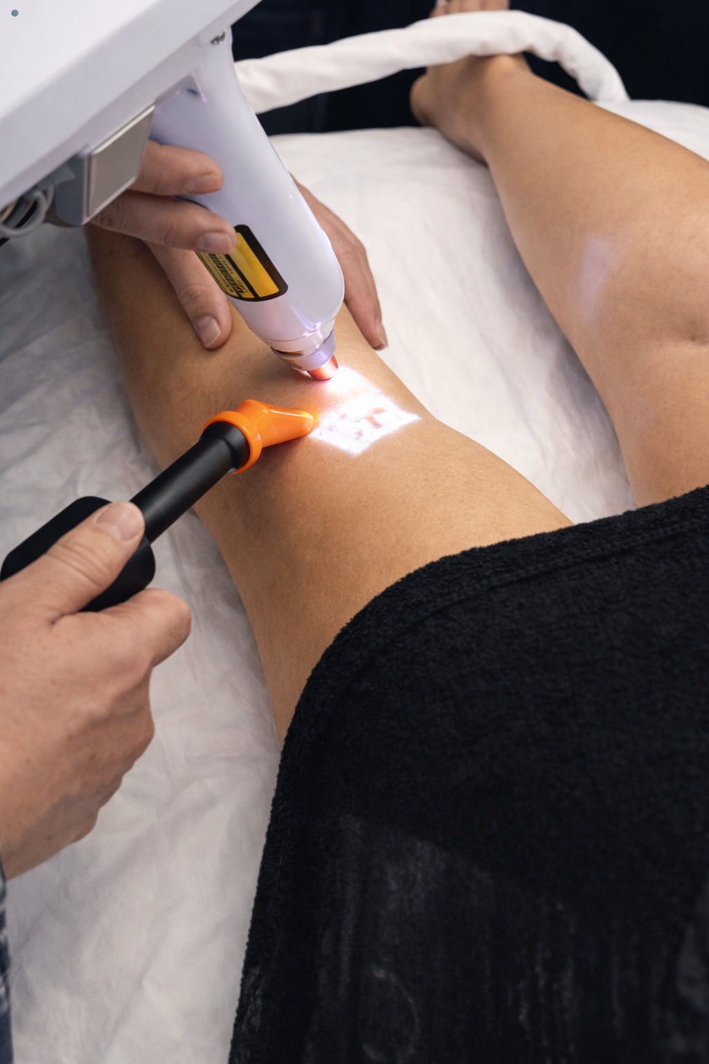 Person receiving laser hair removal treatment on their leg.
