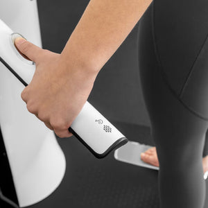 Person hold the white handle of an InBody Body Composition Analyzer (970s) with a gray background
