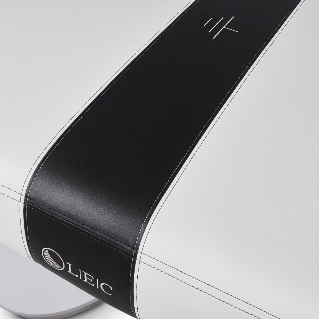 Close up view of LEC INSIGNIA 2.0 WAVERLY™ multi-purpose treatment table with a replaceable mattress illustrating the Earthconnect grounding system.