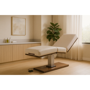 Beige LEC Pedestal examination table in a medical wellness setting with a plant and window in the background.