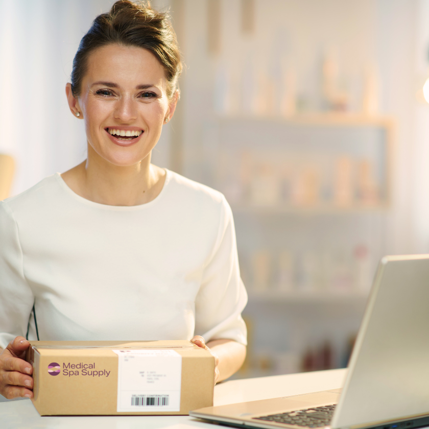 Smiling woman with Medical Spa Supply box of supplies