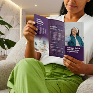 Person holding a brochure about nitrous oxide in a modern Med Spa