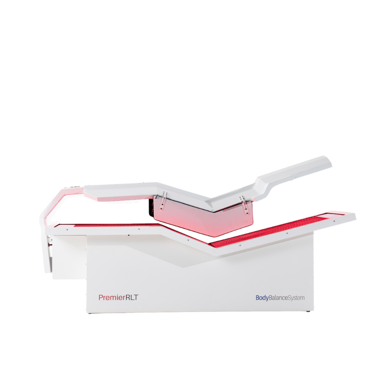 Body Balance System Premier RLT red light therapy bed on a white background with door open and lights on