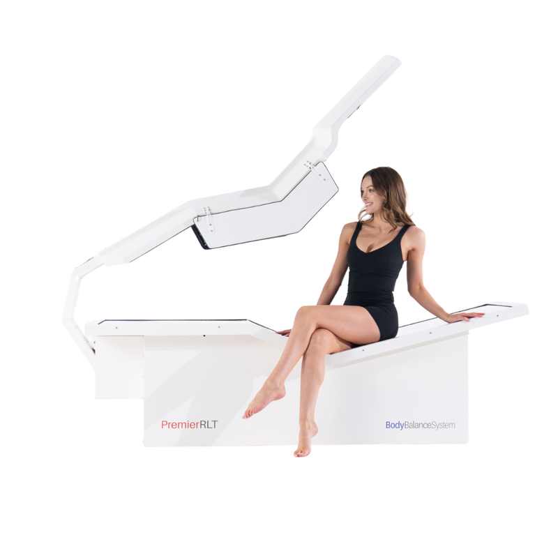 Body Balance System Premier RLT red light therapy bed on a white background with model