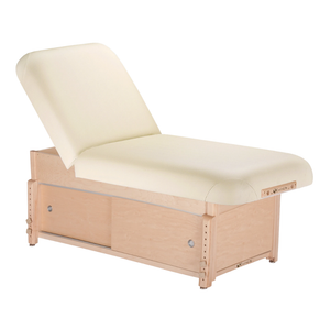 Earthlite Sedona Manual Tilt Massage Table with Vanilla Creme upholstery and enclosed cabinet base for storage in med spa and medical wellness practices.