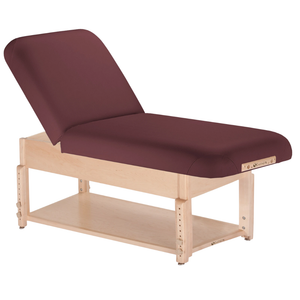 Earthlite Sedona Manual Tilt Massage Table with Burgundy upholstery and open shelf base for storage in med spa and medical wellness practices.
