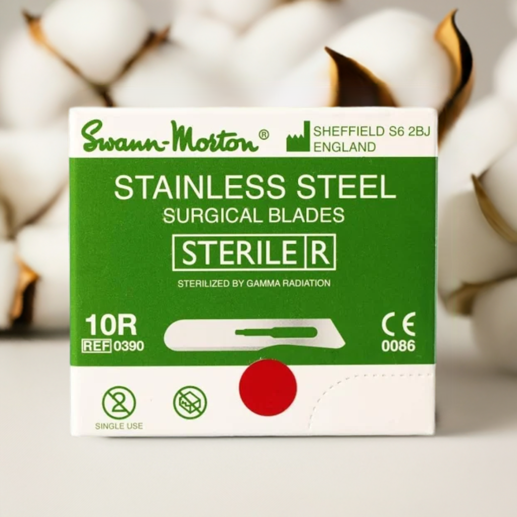 Box of Swann-Morton stainless steel surgical blades with a blurred cotton background