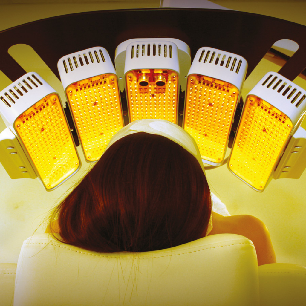 Woman using Silhouet-Tone Soli-Lite Photobiomodulation Yellow light (411569) while lying down.
