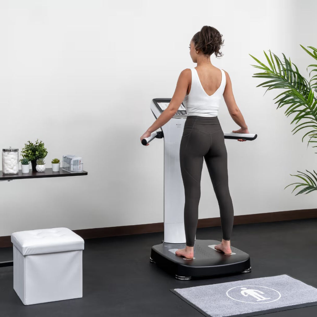 Woman a  InBody Body Composition Analyzer (970s) in a medical wellness setting with plants and a white wall.