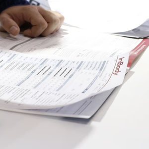 Person holding inBody body composition results with 'InBody' branding on a white surface
