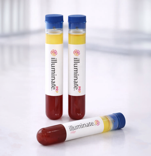 Three 'illuminate' PRP tubes with blue caps and blood and plasma liquid on a Med Spa background